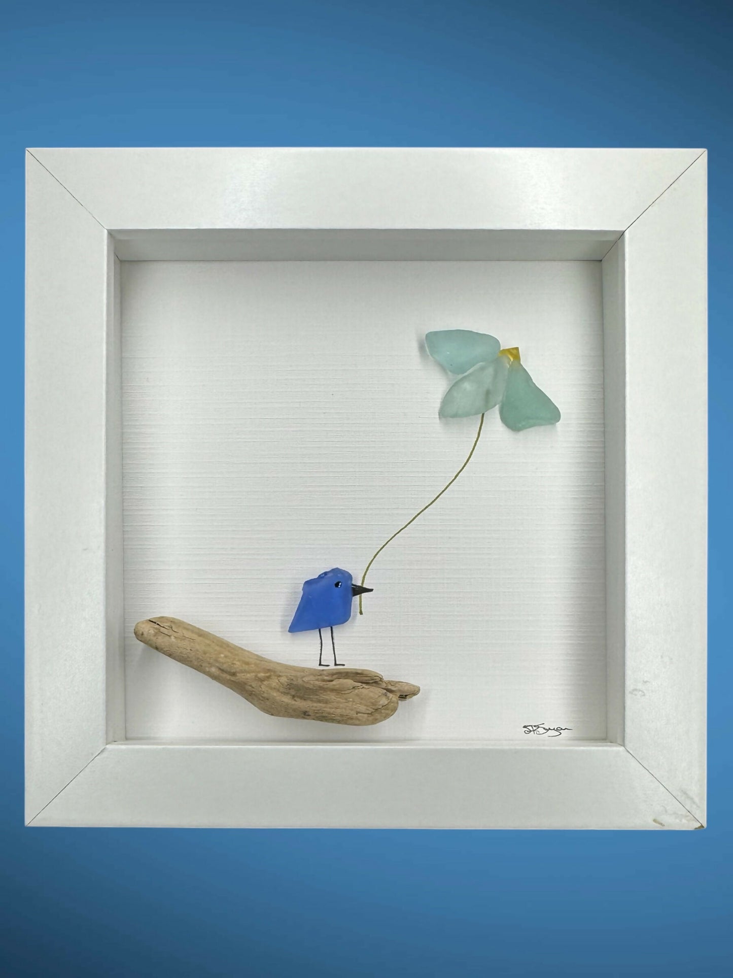 Blue bird on branch holding flower