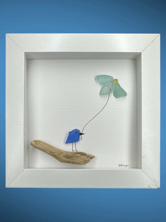 Blue bird on branch holding flower