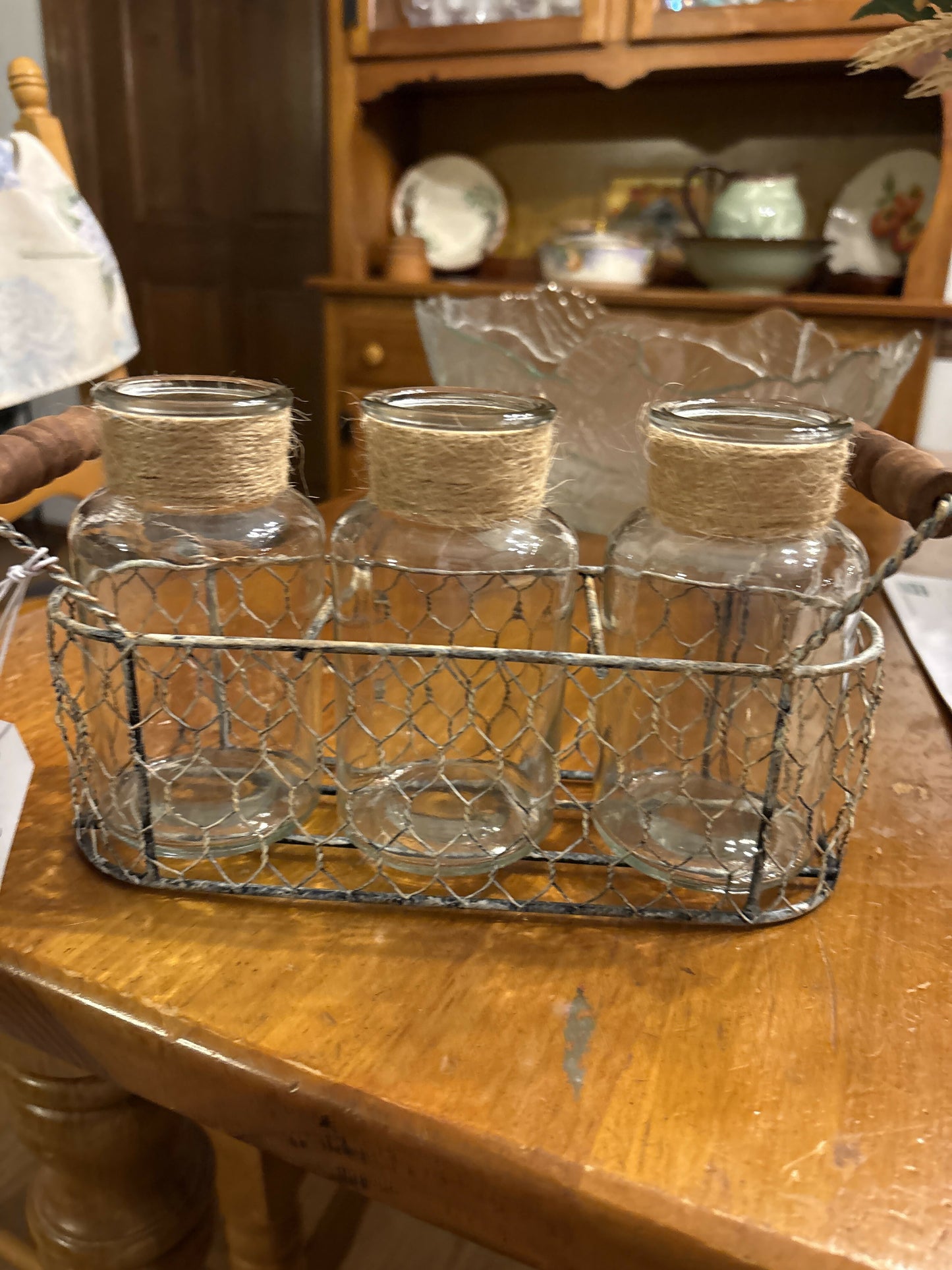 Three jars in a wire basket