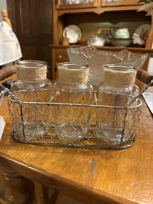 Three jars in a wire basket